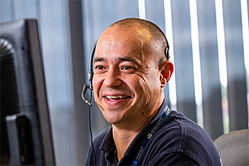 Image of call advisor smiling on the phone