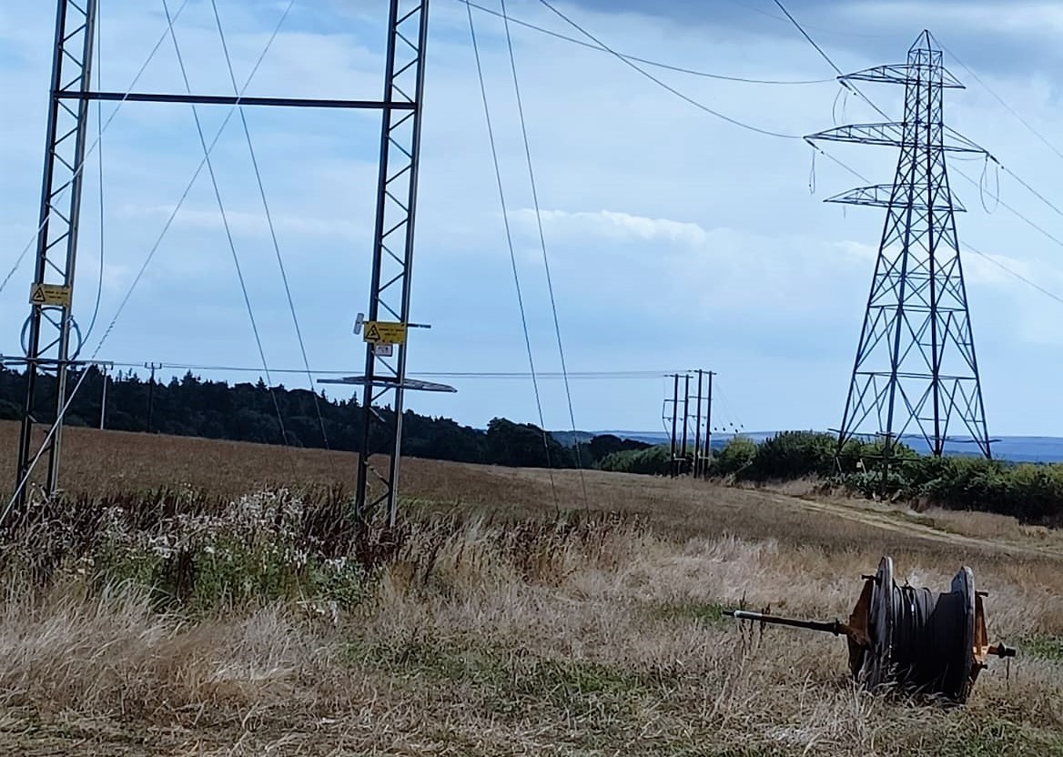 Overhead towers and cables in rural setting