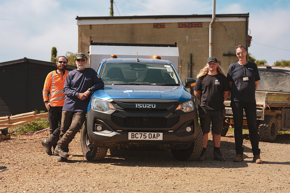 Sanctuary team and Arborist teams standing next to vehicle