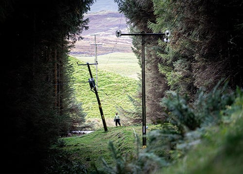 An engineer inspecting part of the damaged network