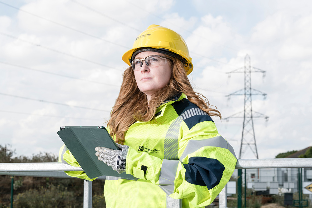 Woman outdoors in high vis and hard hats