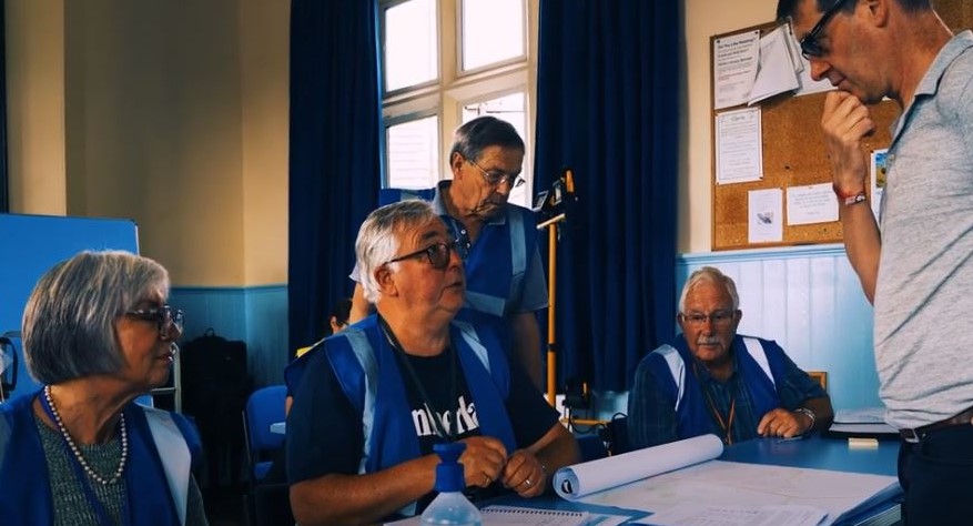 Men and woman carrying out emergency exercise