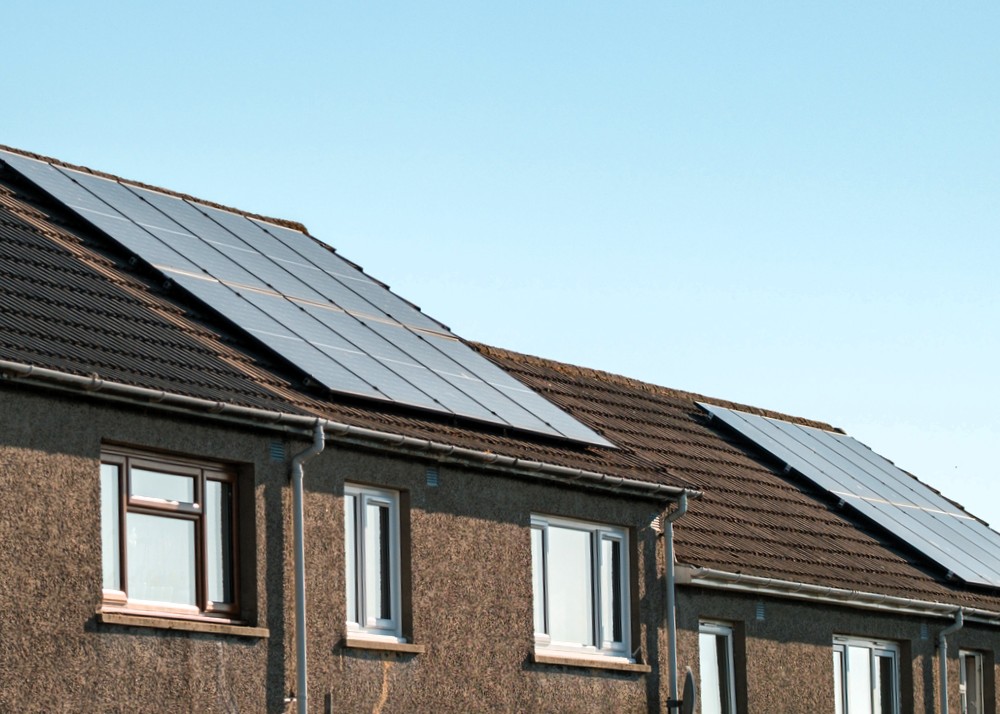 A small terraced house with rooftop solar panels