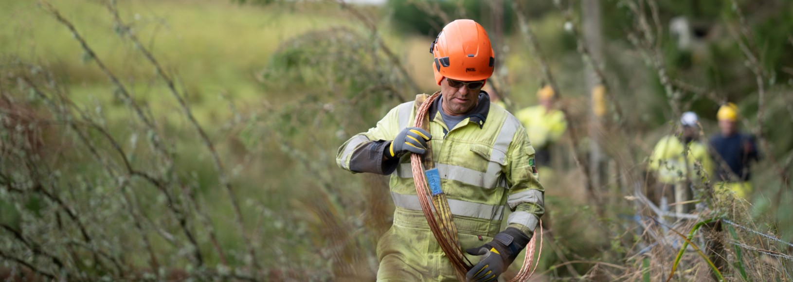 A linesperson carrying our network repairs carrying cable