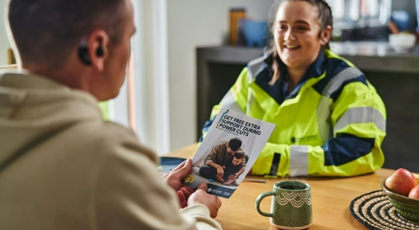 Woman in high vis with customer