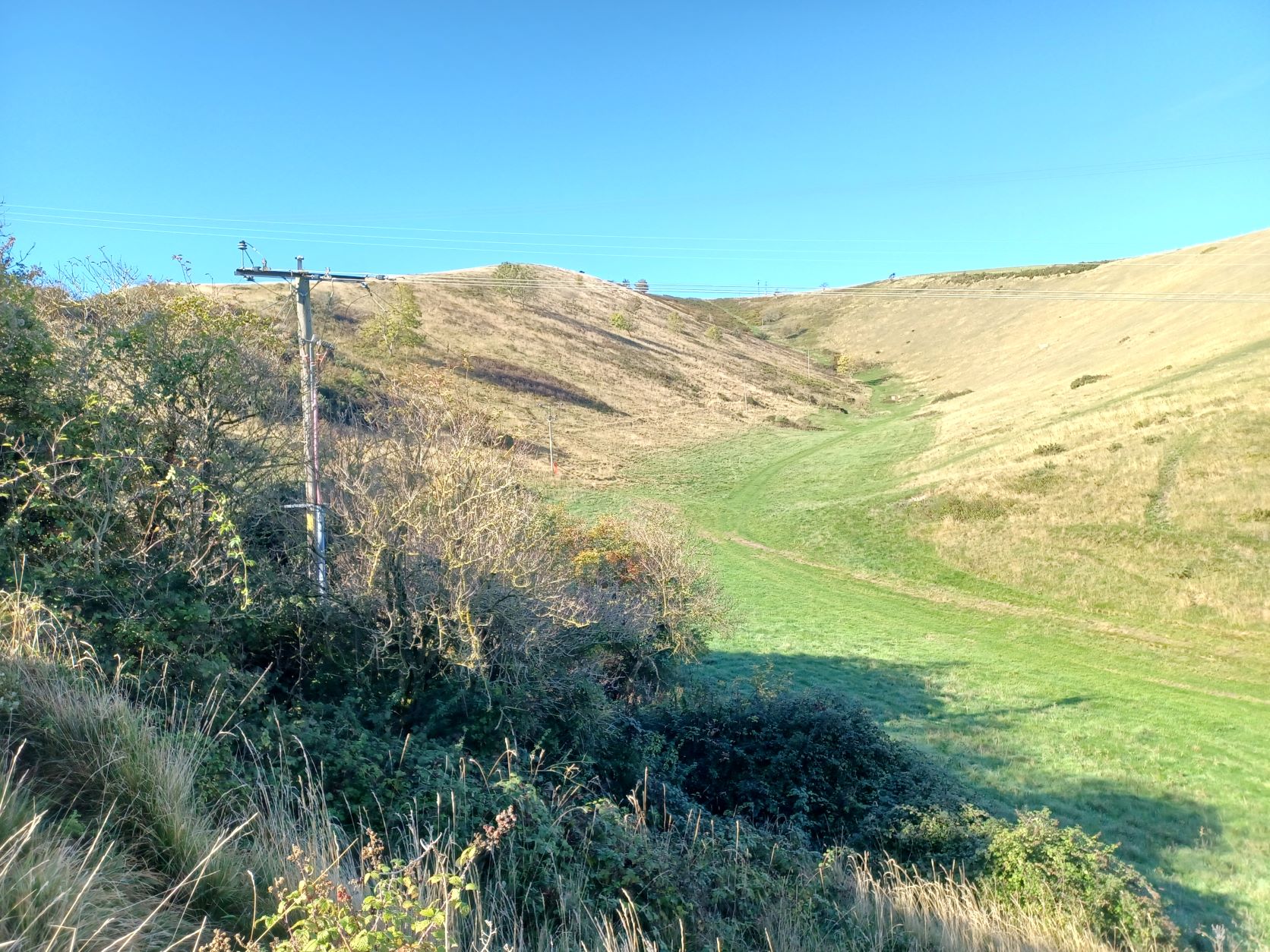 Landscape view of cable running up hill