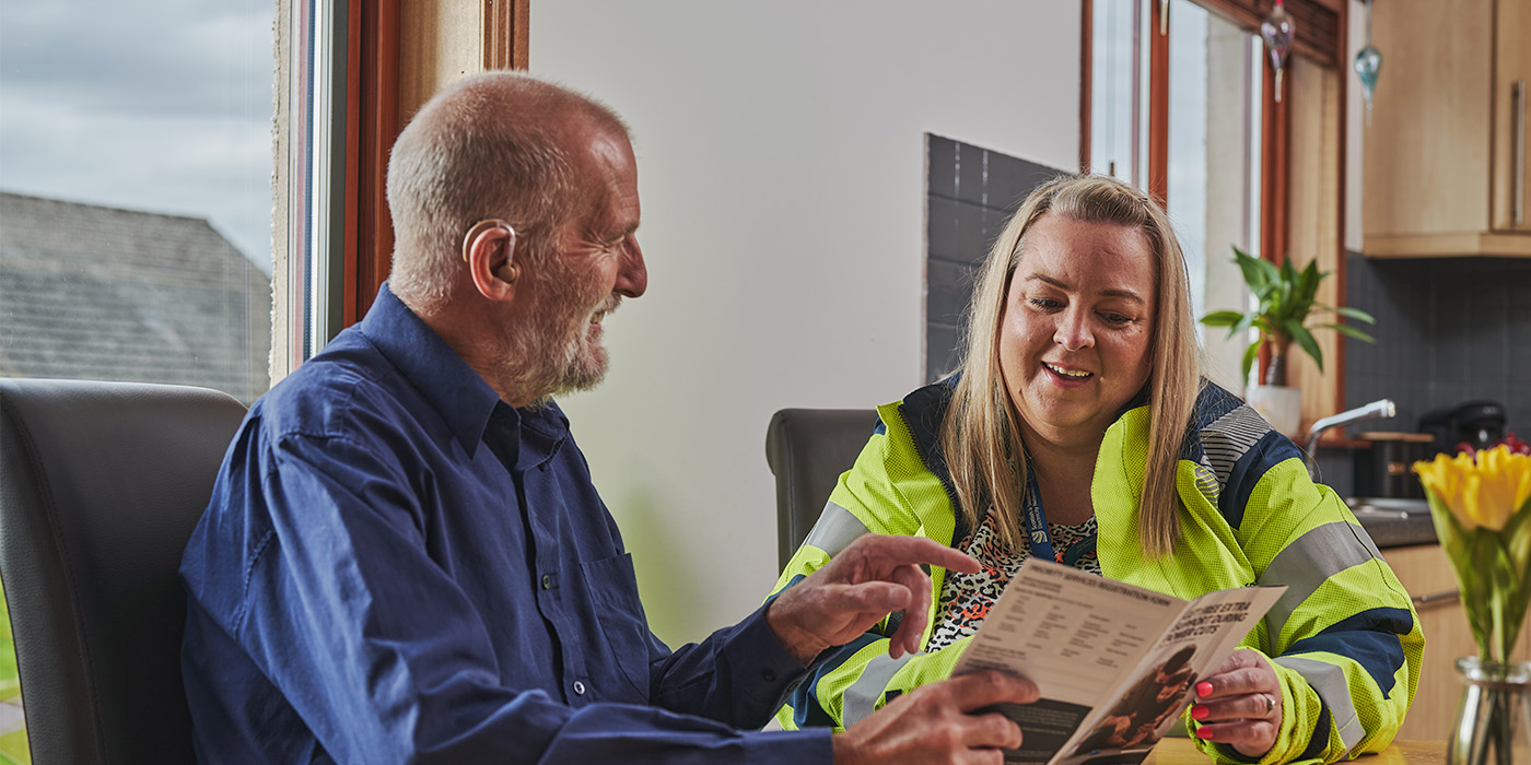 SSEN staff member handing over PSR leaflet