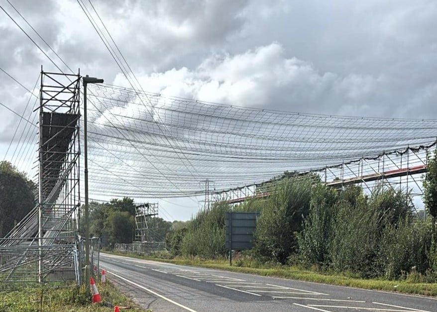 The scaffolding in place where the networked crossed over a road The scaffolding in place where the networked crossed over a road