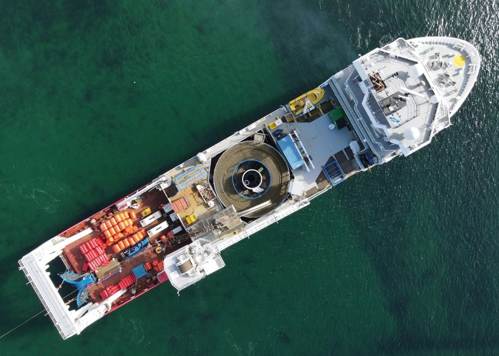 An aerial view of a cable-laying vessel