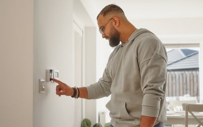 A resident turning down their heating control to use less power at an agreed time of the day