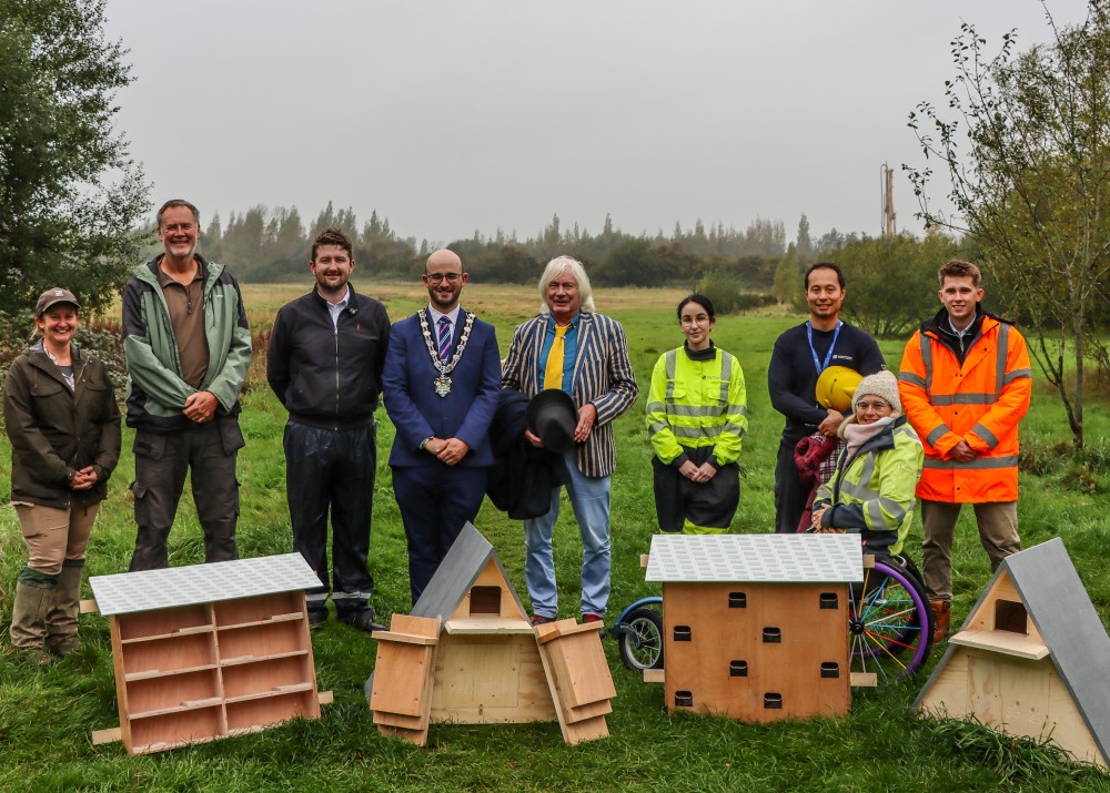 The team marking the repurposing of old electricity network poles into locations for bird boxes