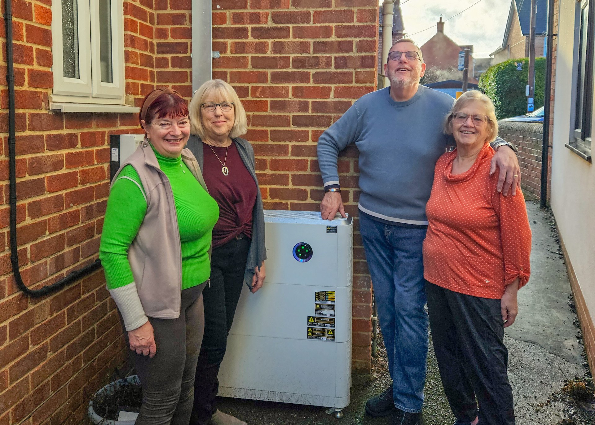 The four trustees of the Dilton Memorial Hall stand in front of their newly-installed heat pump