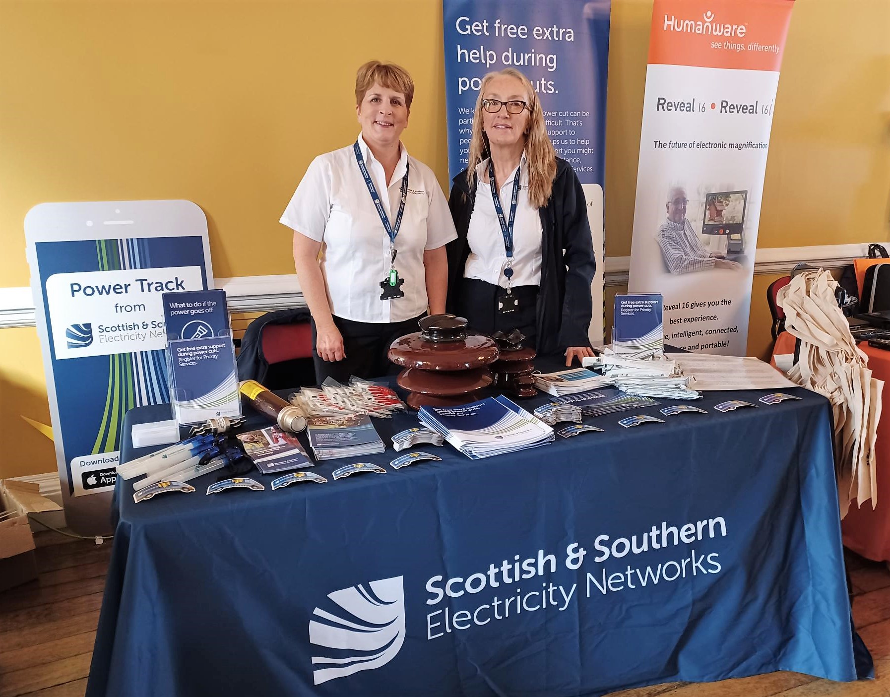 Two female SSEN staff at indoor display stand