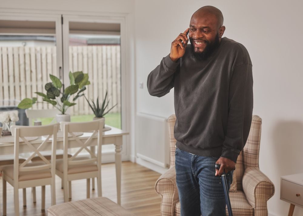 A genteman using a walking stick on the phone to SSEN A genteman using a walking stick on the phone to SSEN