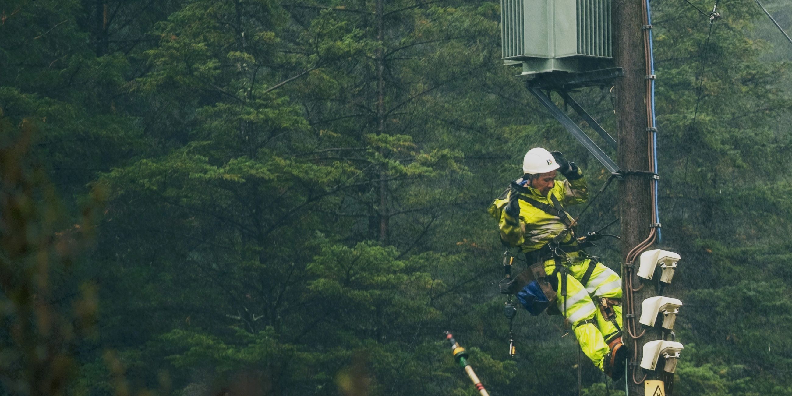 An SSEN engineer working at height to repair the network