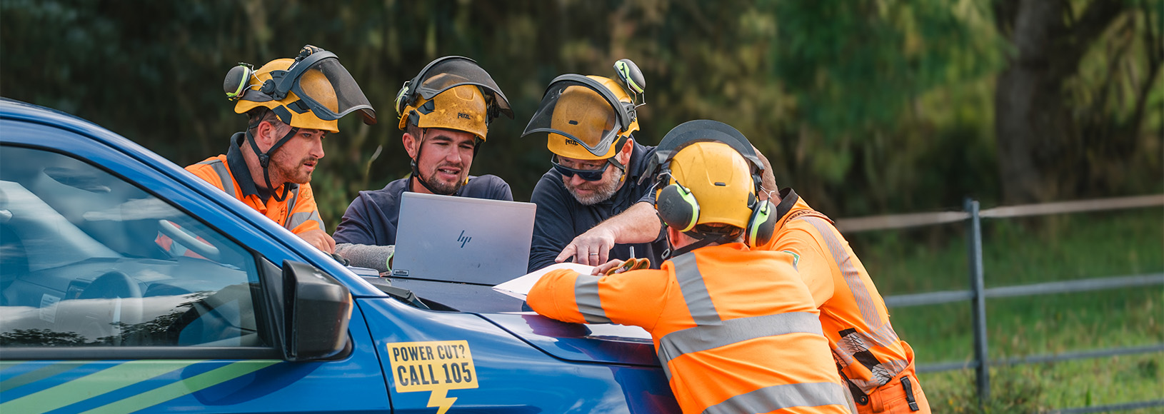 SSEN Engineers walking in front of vans in forest