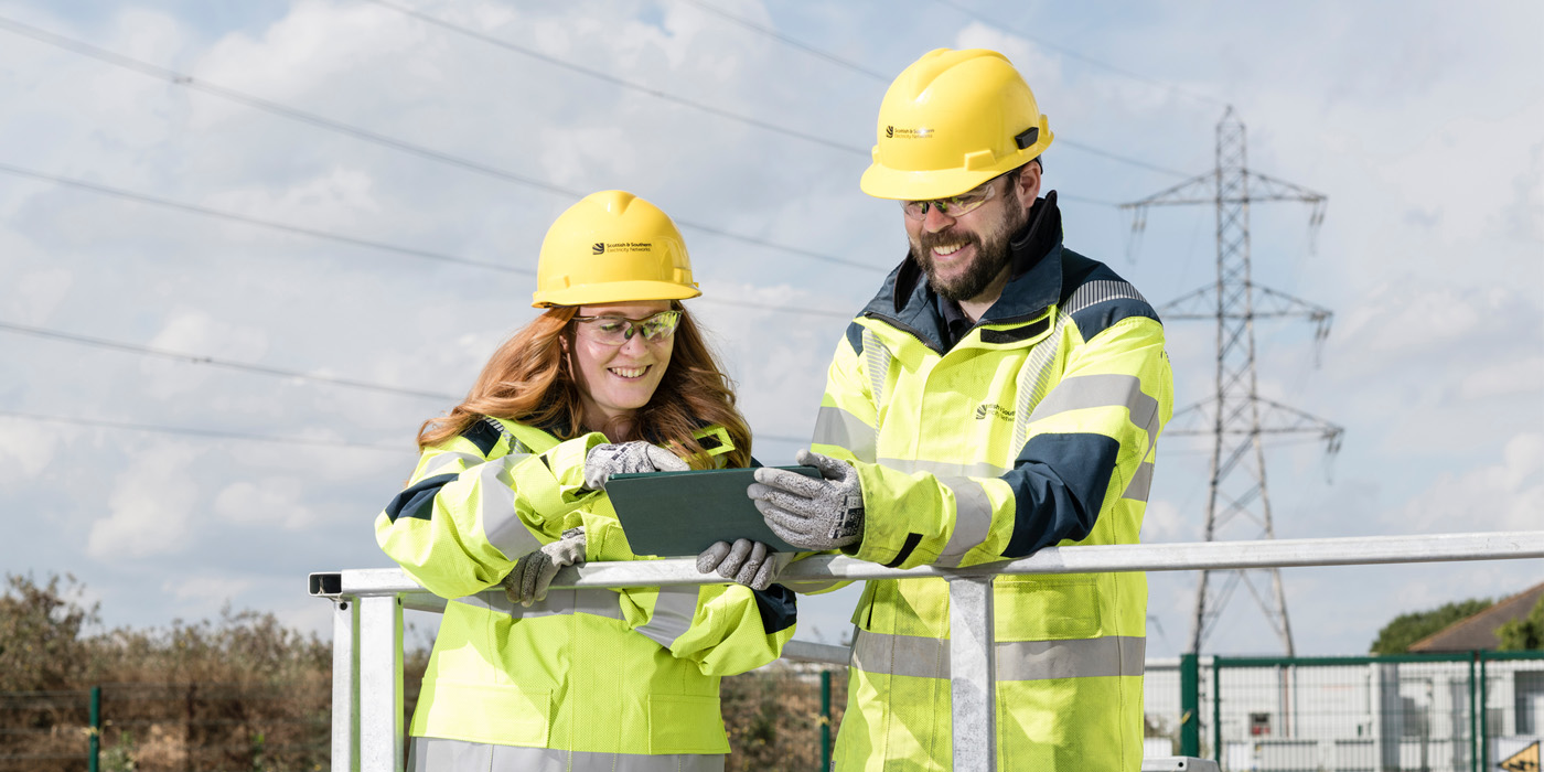 Engineers outside in front of pylon