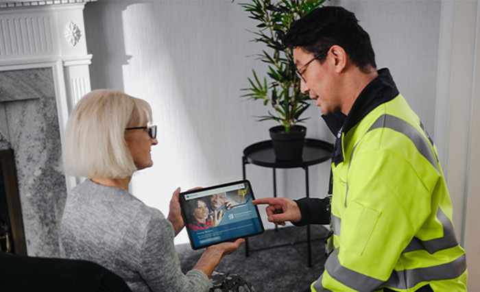 SSEN engineer sitting with elderly customer