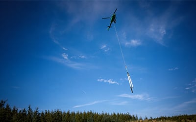 Helicopter carrying poles as part of Portree-Dunvegan network upgrade Aug 2026