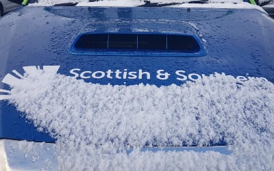 An SSEN Distribution vehicle bonnet covered in snow