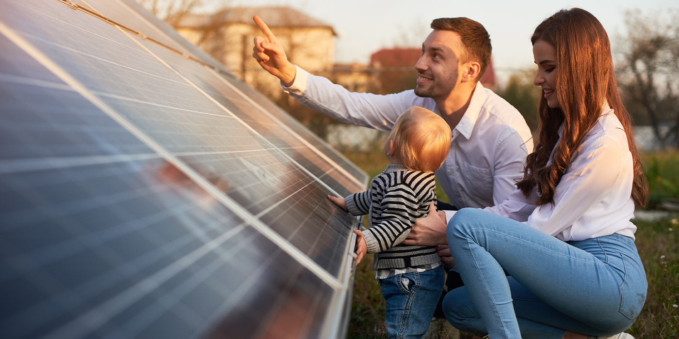 Image of family looking at solar panels in garden