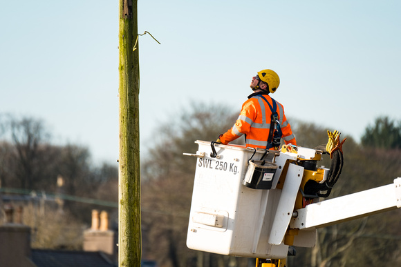 Linesman Finlay Milne, working 'Live' to replace a wooden pole without interruption to local supply