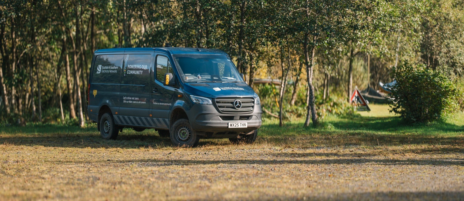 SSEN Van driving on woodland road.