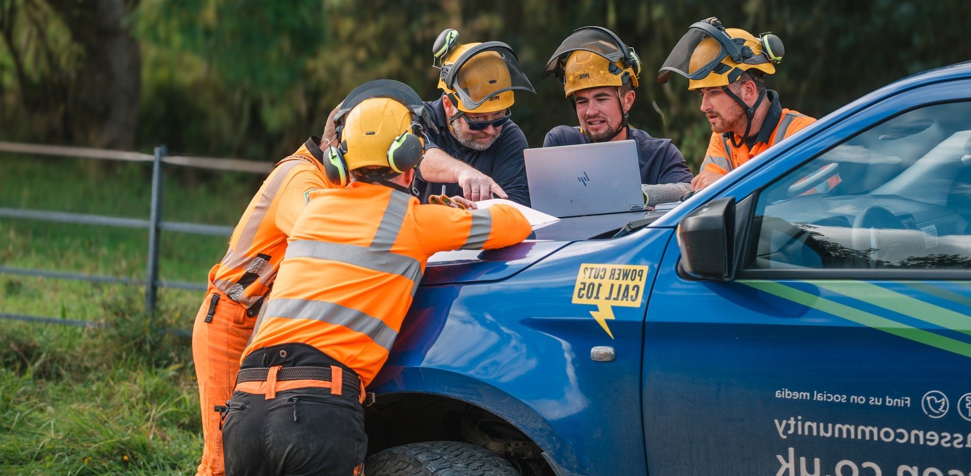  SSEN Engineers working on laptop atop of SSEN van.