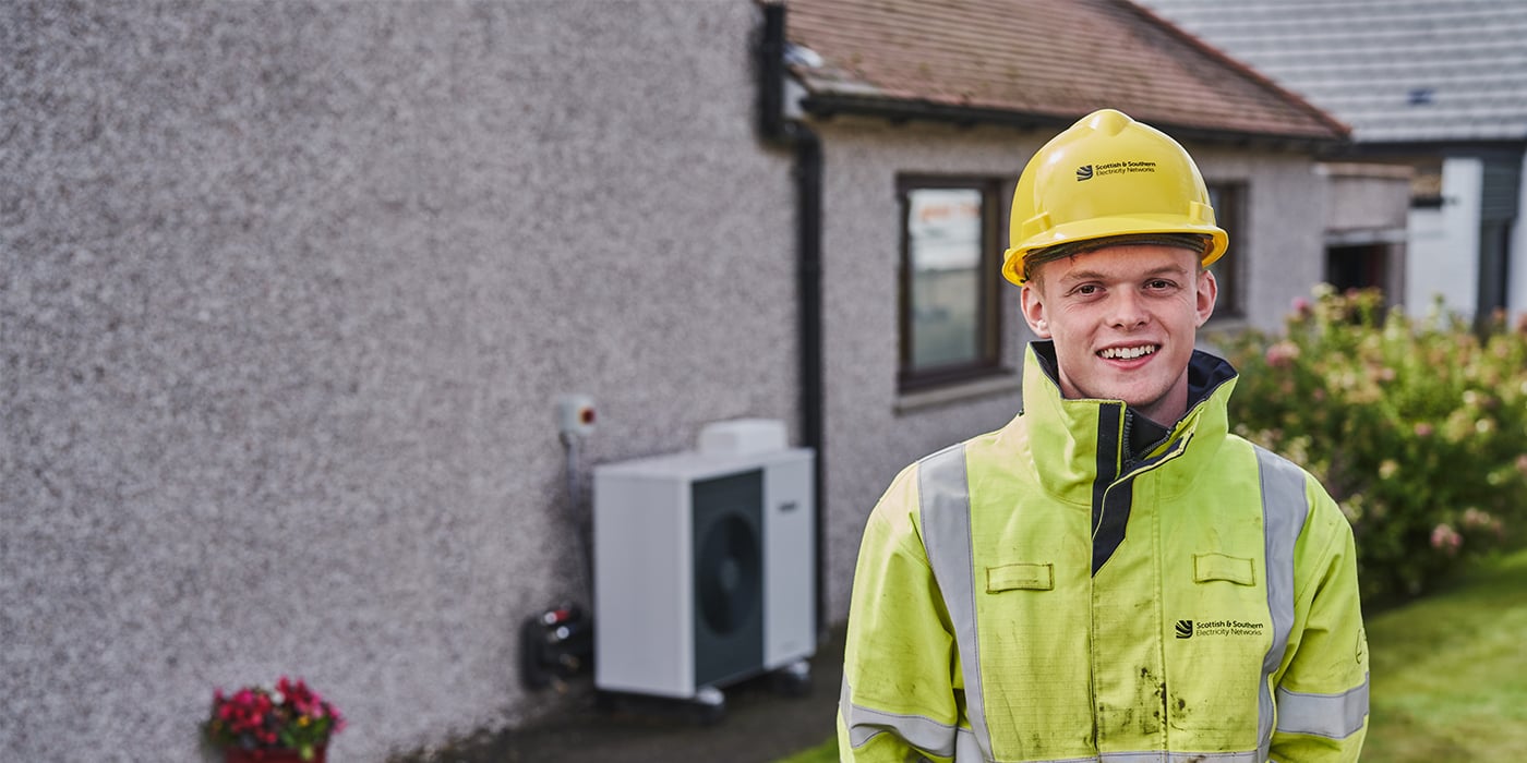 Image of engineer with in front of property.