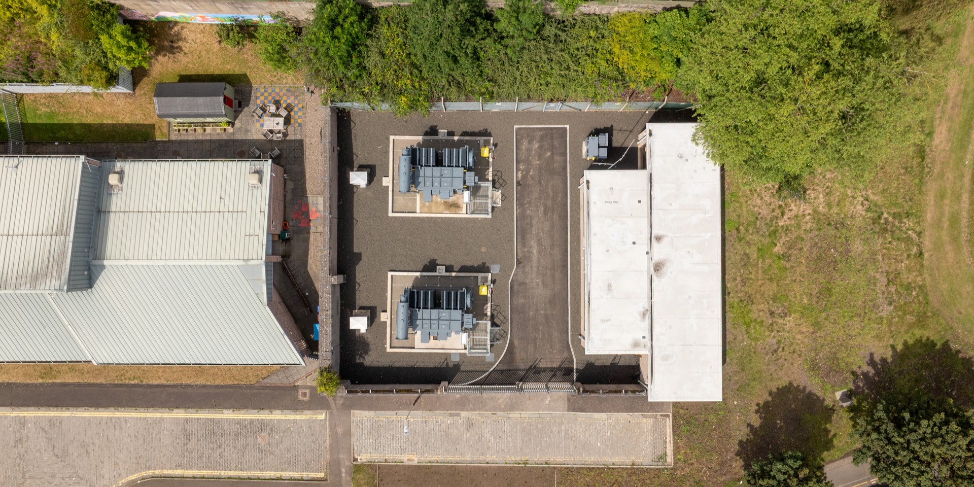 Bird's eye view of a newly-upgraded electricity transformer, surrounded by woodland