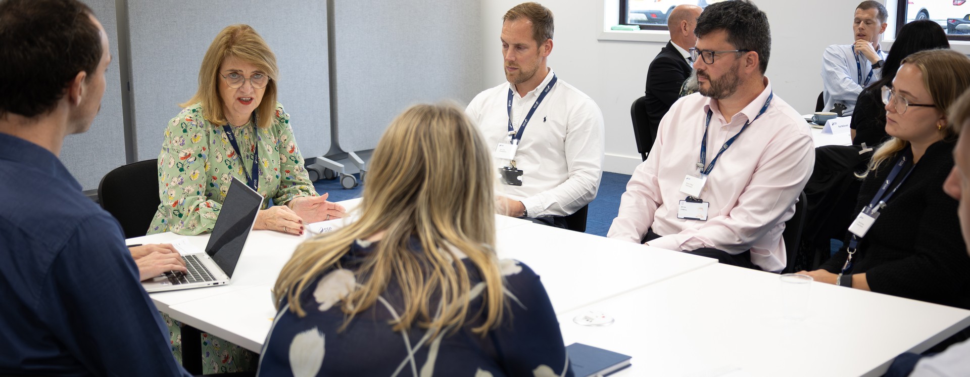 SSEN Employees meeting and discussing around a table.