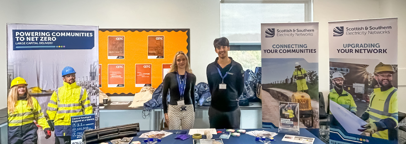 Two of the SSEN team members who volunteered their time at the careers event standing at their stall