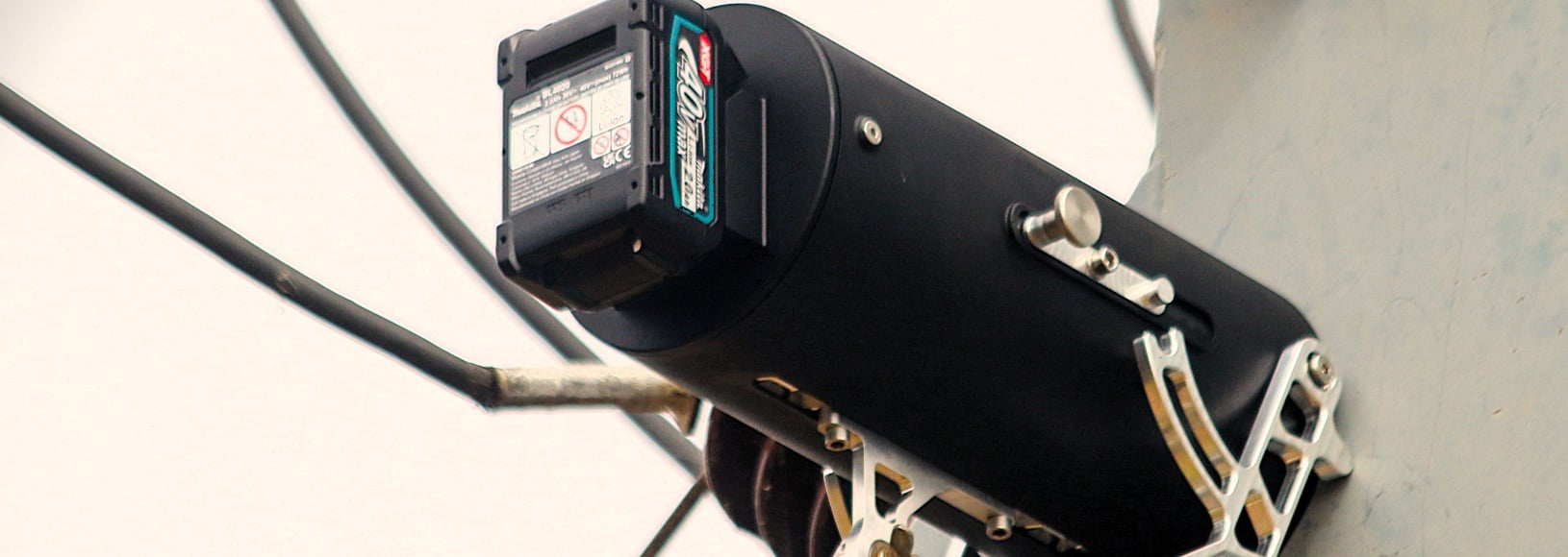 A close-up of the Lancet cordless drill being used on a pole-mounted transformer