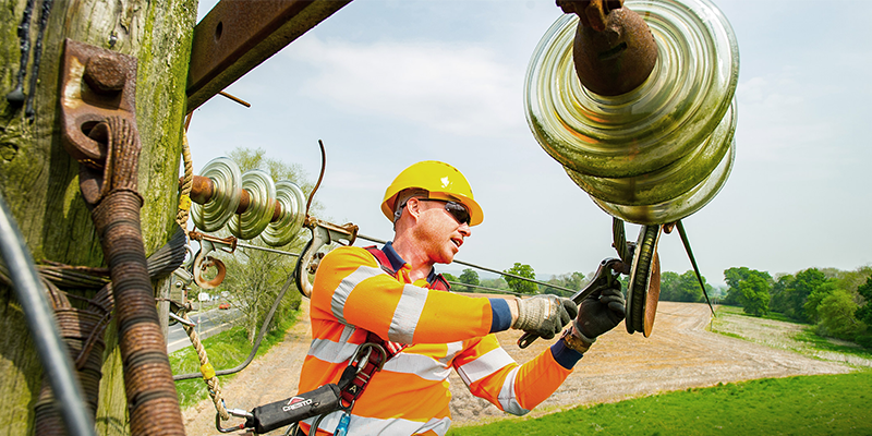 Image of engineer fixing conductor on overhead power lines
