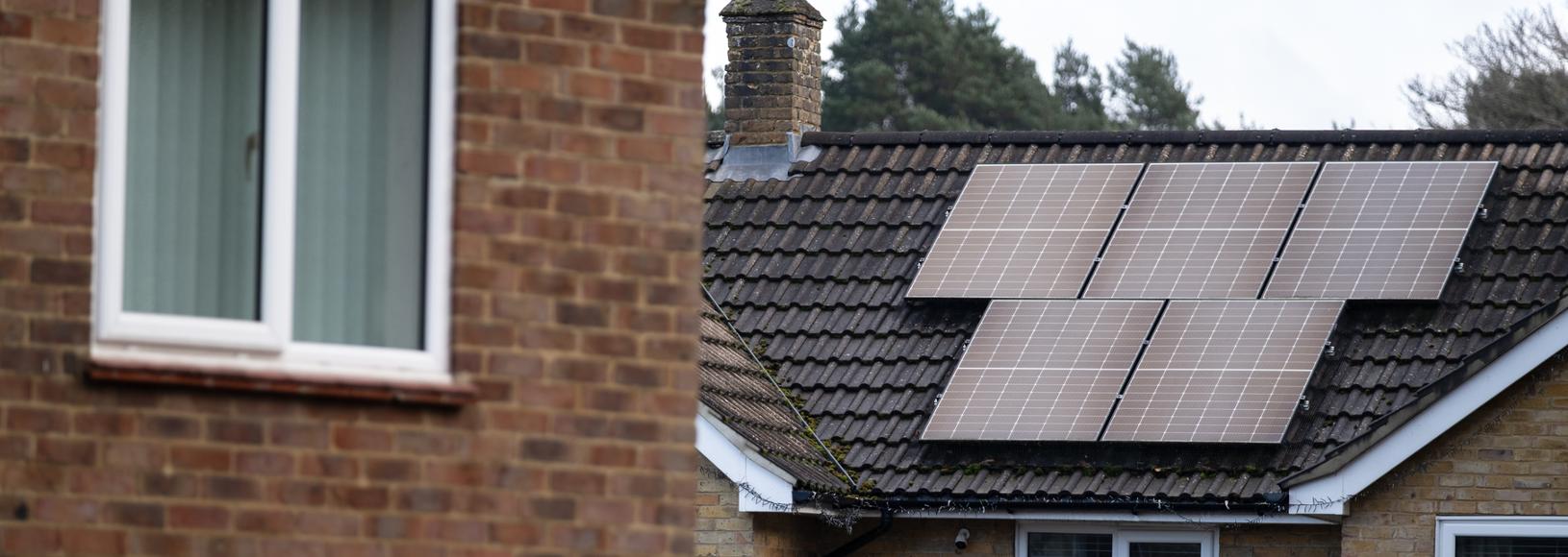 A close up of a modern home with solar panels on its roof
