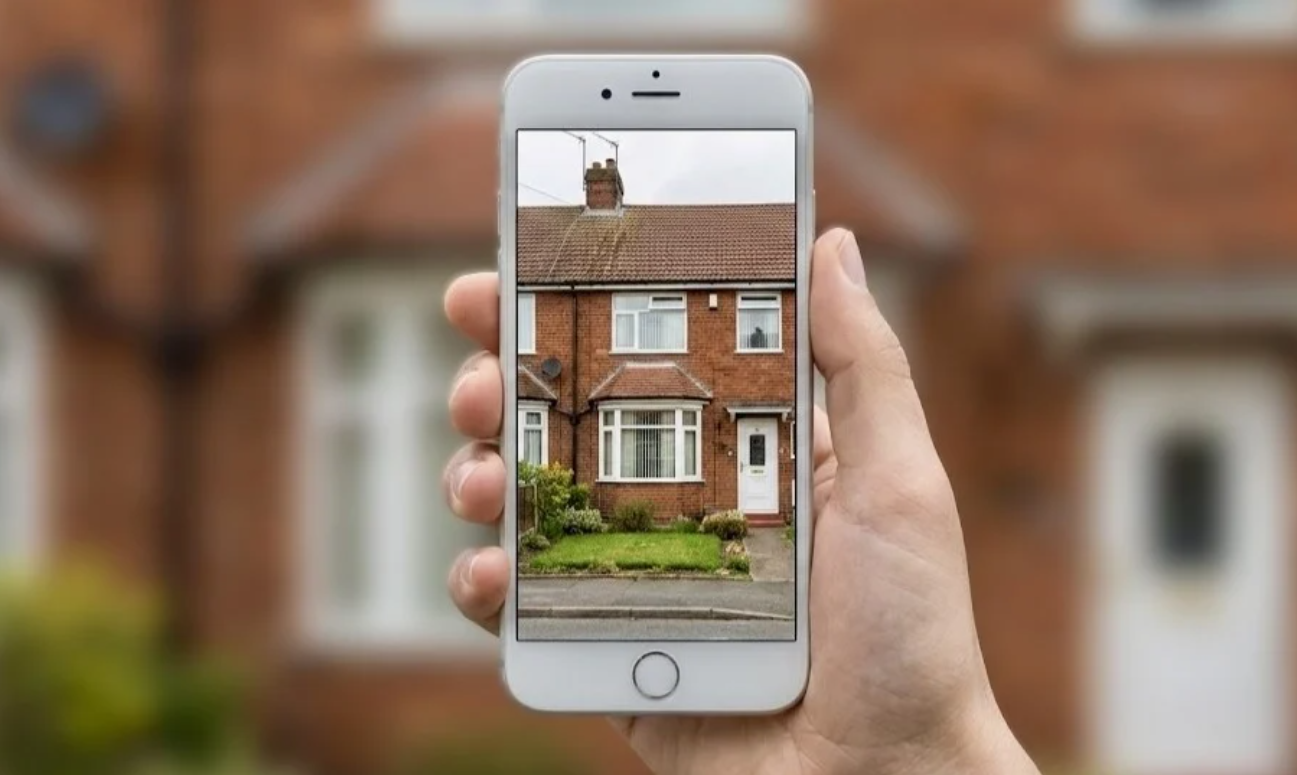 A person using their smartphone to gather footage of the electricity equipment within their property