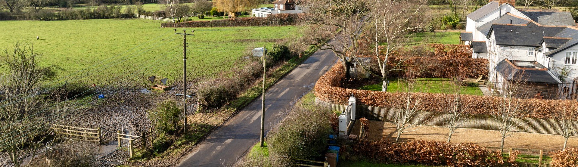 Overview of farmland, with SSEN pylon and housing in view.