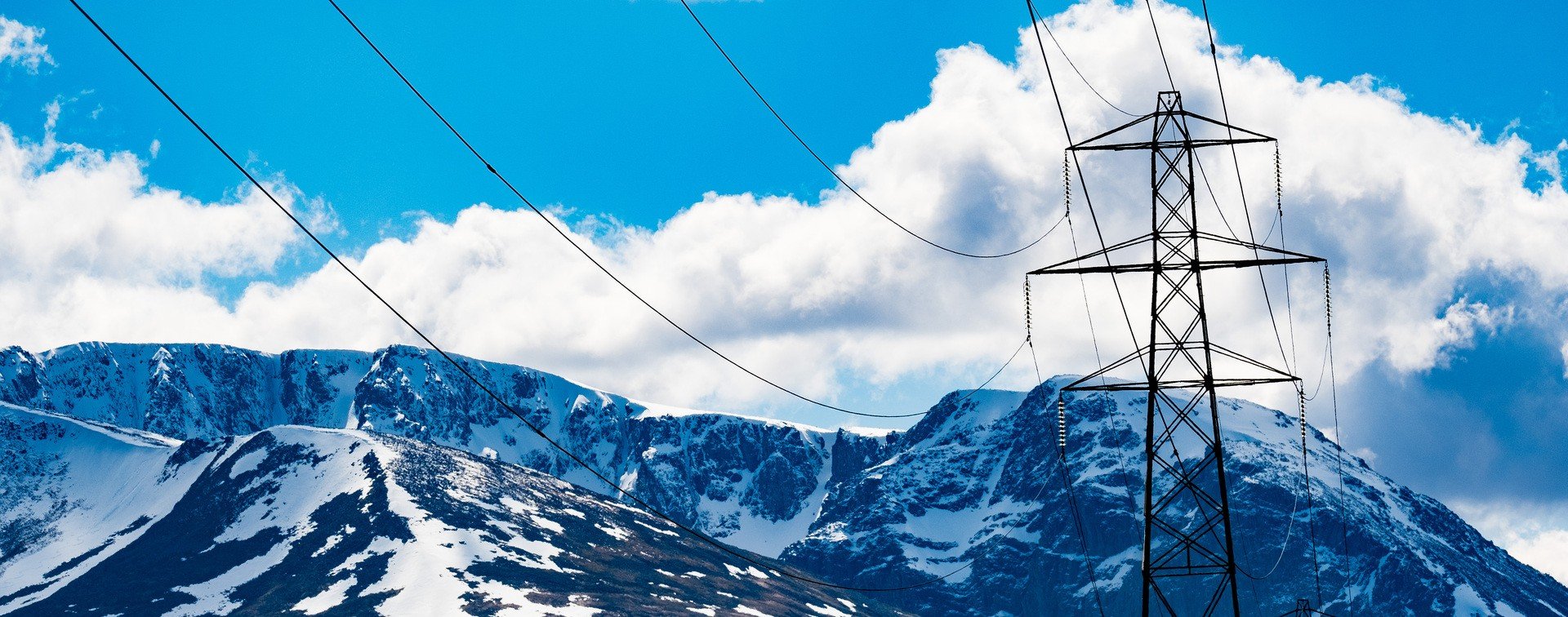 Mountains in background, electricity tower in foreground.