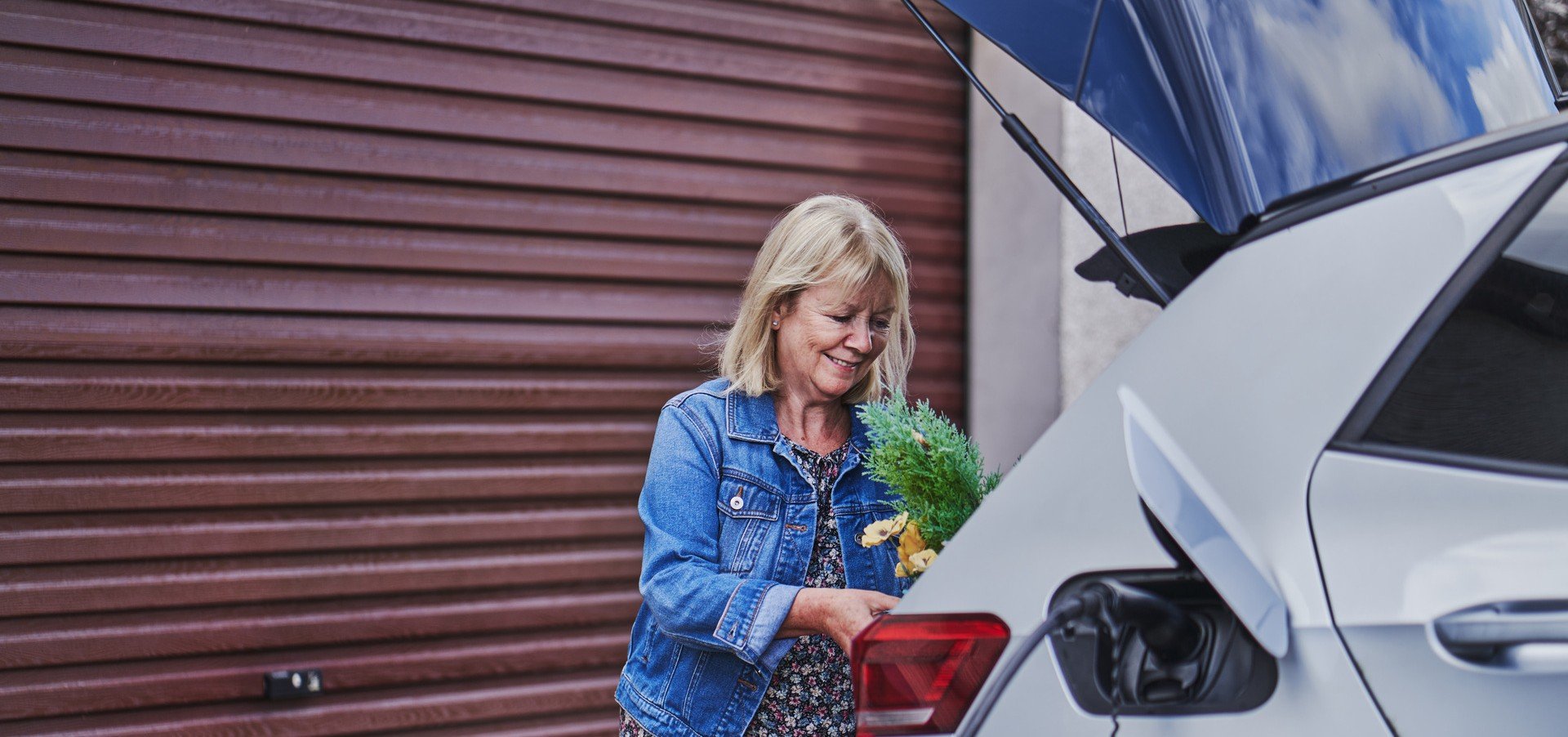 Woman charging her electric vehicle.